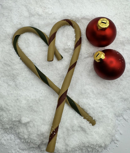 Dog treat candy cane in  a heart, in the snow