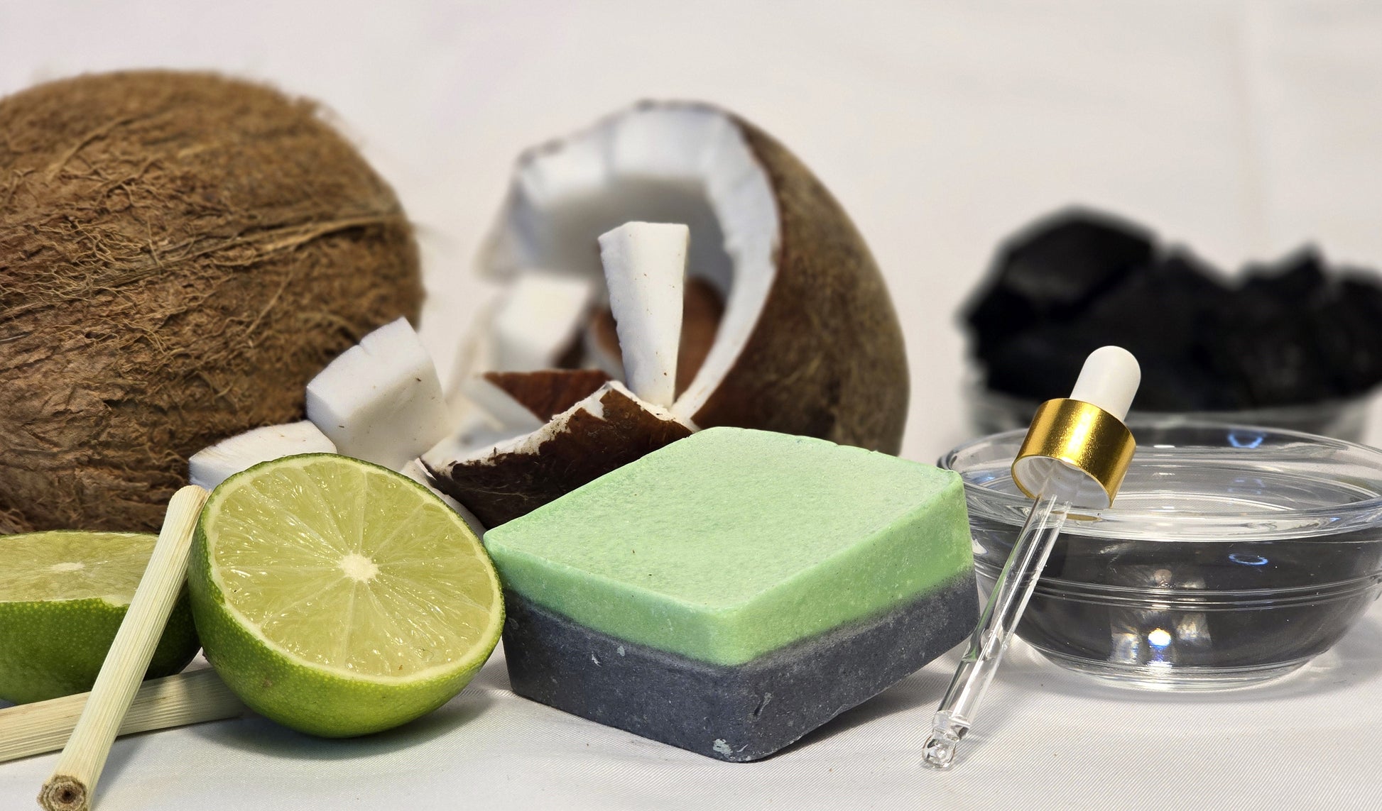 Green lemongrass and bergamot dog shampoo bar with ingredients pictured, coconut, activated charcoal, bergamot and lemongrass